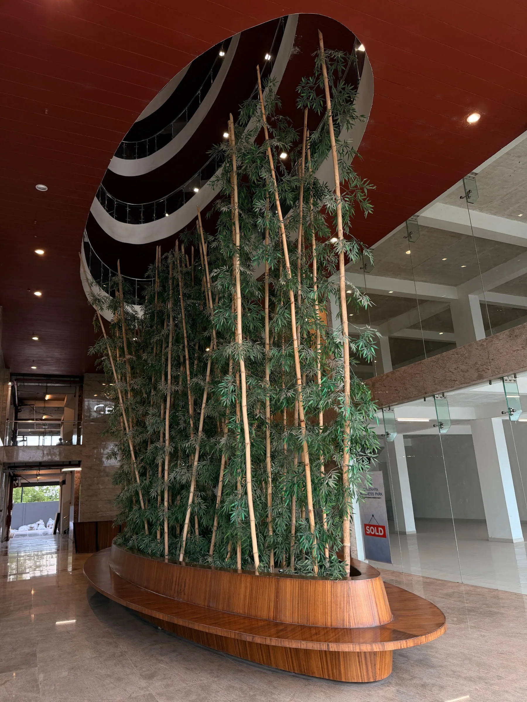The lobby, with bamboo planting rising through a curved timber planter