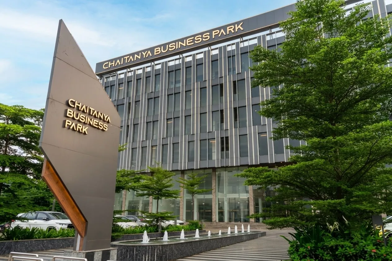 The Chaitanya Business Park monument sign and glazed entrance, seen from the forecourt